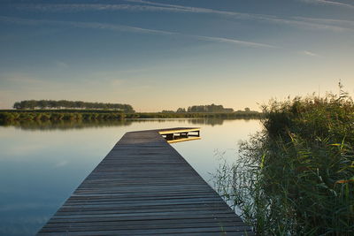 Pier over lake against sky