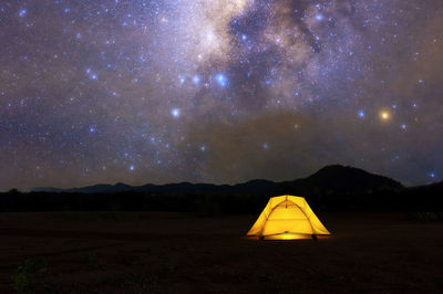 Scenic view of mountains against sky at night