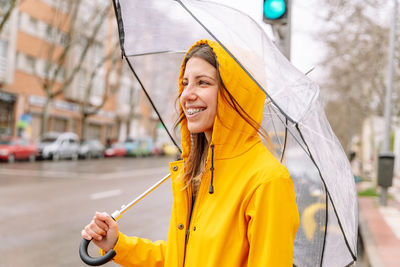 Portrait of young woman holding umbrella