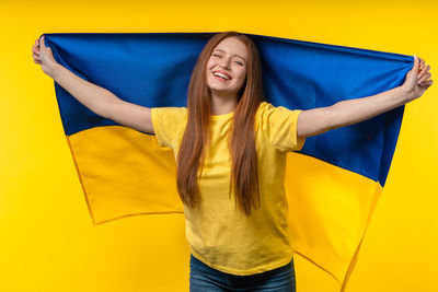Portrait of young woman holding flag