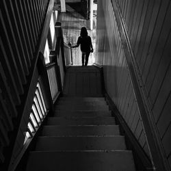 Rear view of woman on stairway