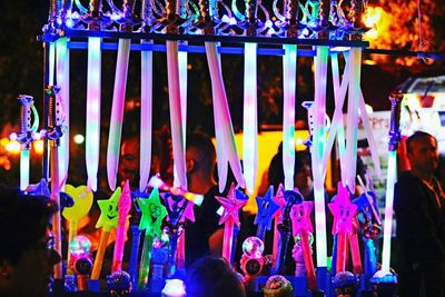 People in amusement park ride at night