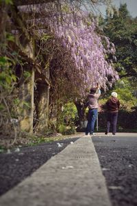 Woman walking on footpath