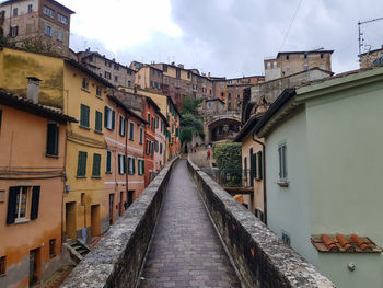 Footpath amidst buildings in town ... 2