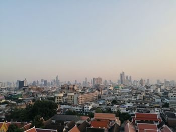 High angle view of buildings in city against clear sky