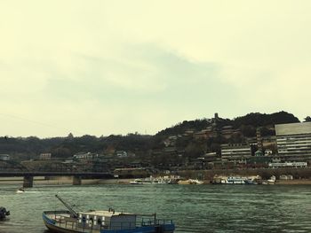 Boats in river with buildings in background