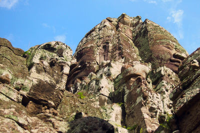 Low angle view of rock formation against sky