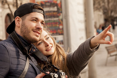 Portrait of smiling young man using smart phone