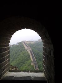 Built structure against the sky seen through arch