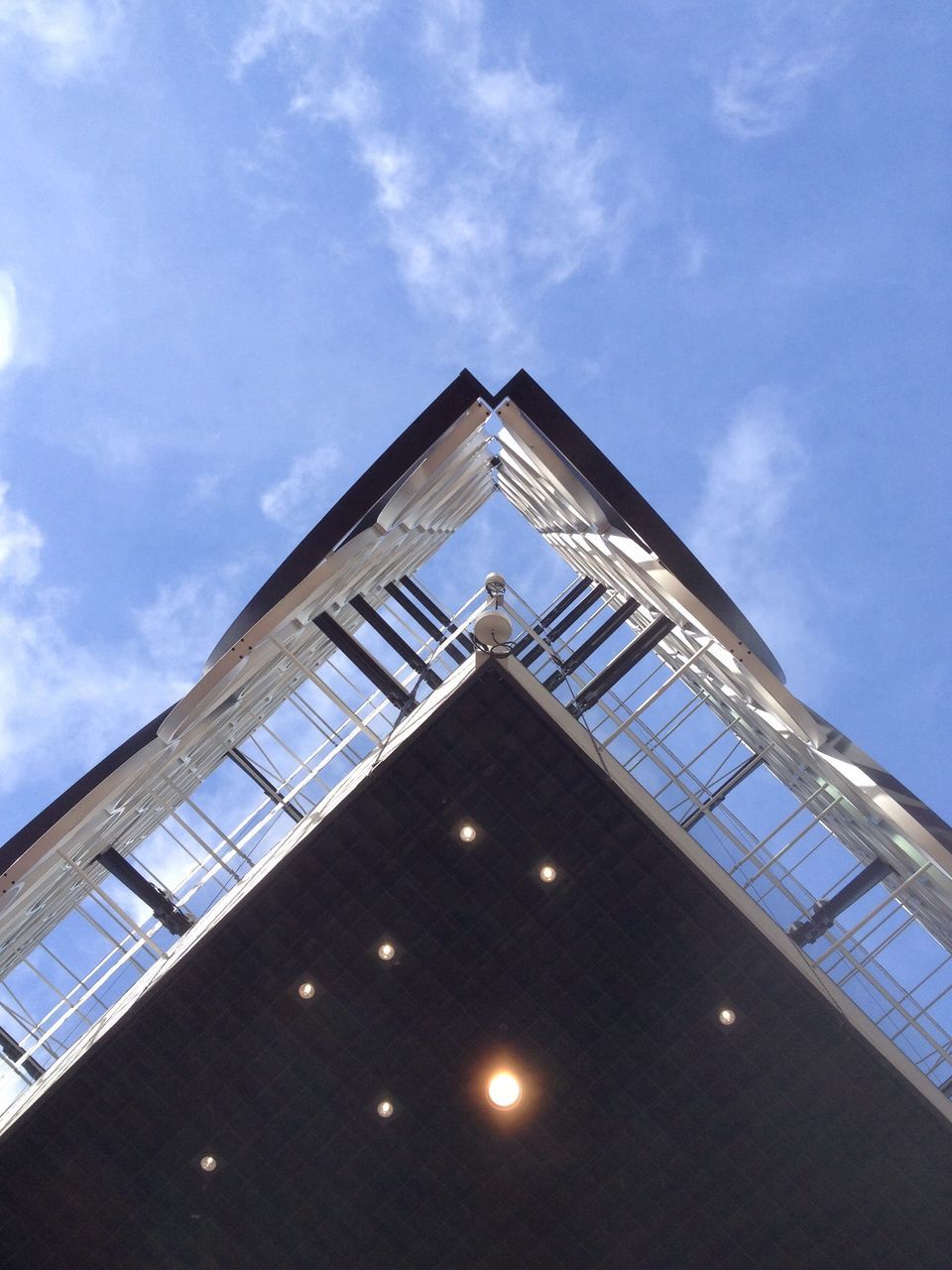 architecture, low angle view, built structure, sky, building exterior, cloud - sky, blue, modern, cloud, glass - material, architectural feature, day, sunlight, no people, building, reflection, outdoors, pattern, window, ceiling