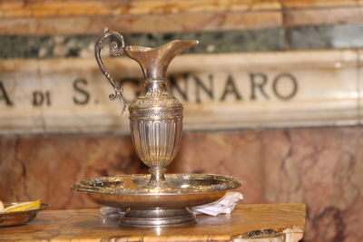 Close-up of wineglass on table against wall