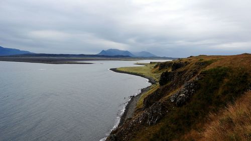 Scenic view of sea against cloudy sky