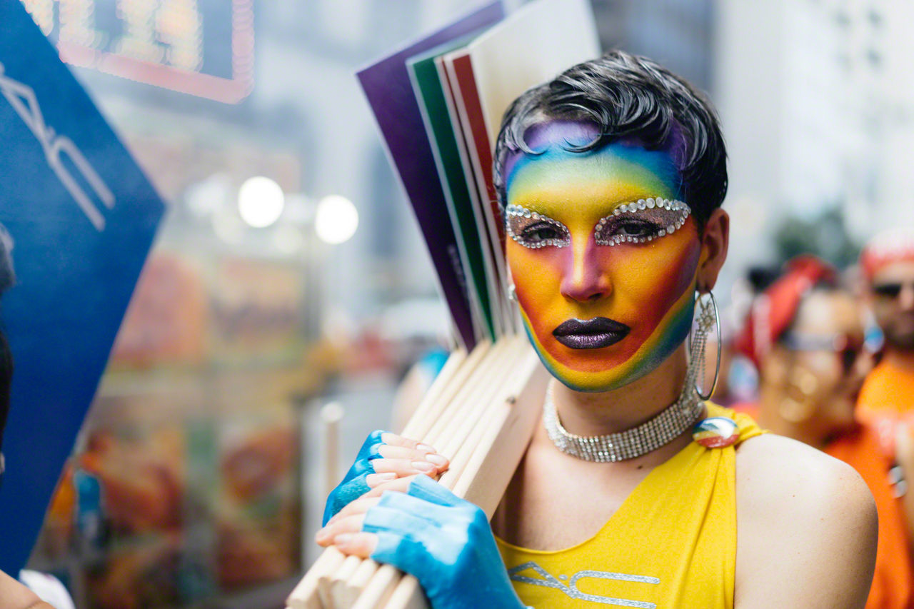 portrait, paint, one person, focus on foreground, headshot, young adult, real people, incidental people, face paint, lifestyles, multi colored, indoors, front view, fashion, leisure activity, young women, adult, carnival - celebration event, beautiful woman, festival