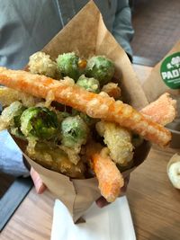 Close-up of person holding food on table