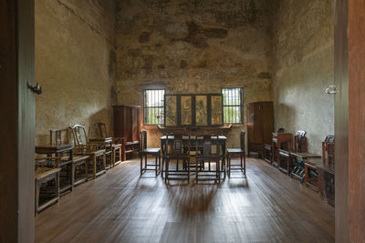 Empty chairs and tables in abandoned building