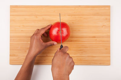 Directly above shot of hand holding strawberry