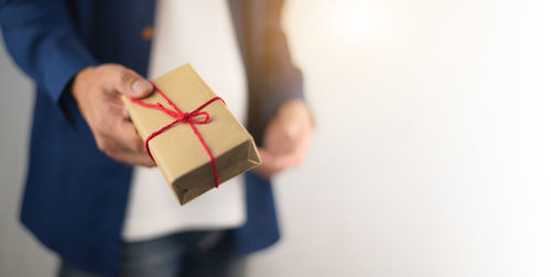 Close-up of hand holding paper box