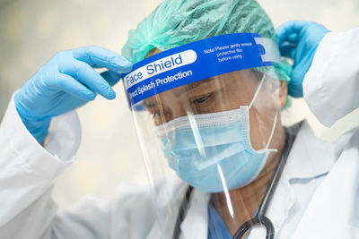 Close-up of doctor wearing face shield at hospital