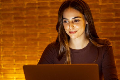 Portrait of young woman using digital tablet