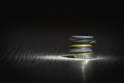 Close-up of electric lamp on table against black background