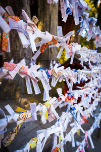 Close-up of various notes tied to railings