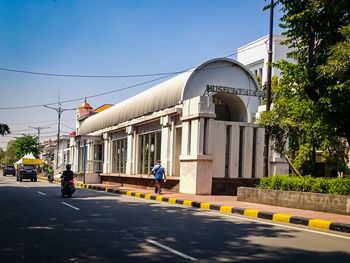 People walking on road against buildings