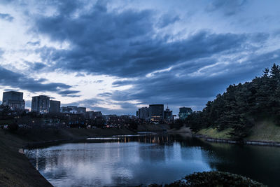 View of lake in city against sky