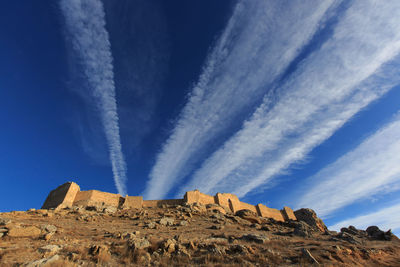 Low angle view of rock formation against sky