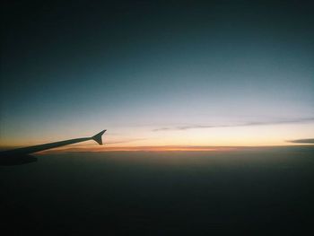 Cropped image of airplane at sunset