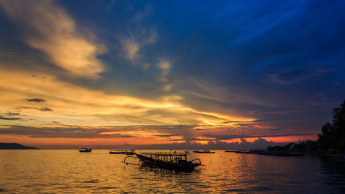 Silhouette boat in sea against sky during sunset