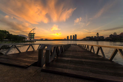 Jetty over sea during sunset