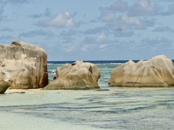 Rocks on beach against sky