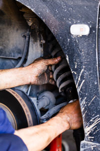 Car mechanic changing tire on the rim in service garage