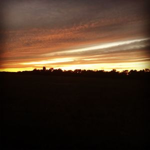 Silhouette landscape against sky during sunset