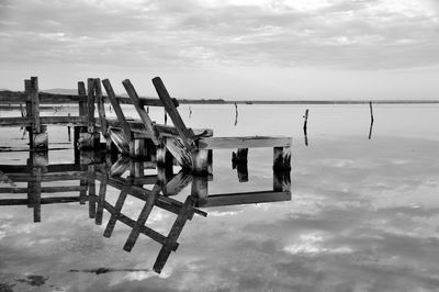 Lifeguard hut in sea against sky