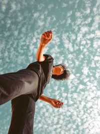 Low section of woman standing under sky