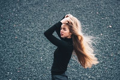 High angle portrait of woman standing on road