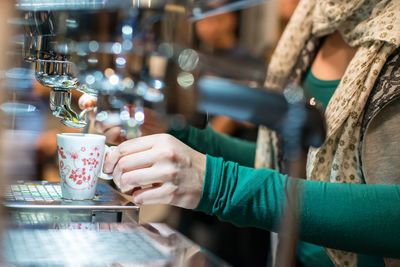 Midsection of man holding coffee