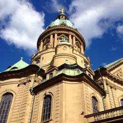 Low angle view of church against cloudy sky