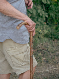 Midsection of man holding plant