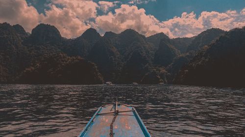 Scenic view of lake by mountains against sky