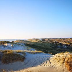 Scenic view of beach against clear sky