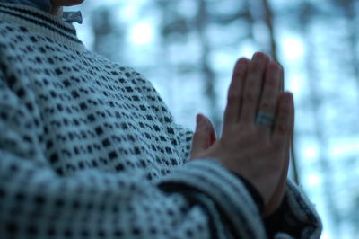 Midsection of woman praying