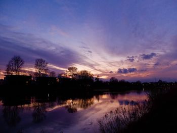 Scenic view of lake against sky at sunset