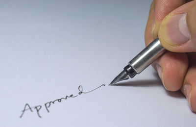 Close-up of hand writing on paper