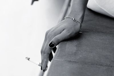 Close-up of woman hand holding cigarette