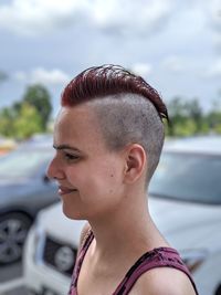 Close-up portrait of woman in car against sky