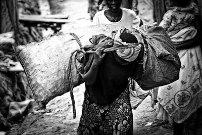 Man carrying sack on footpath