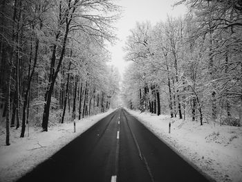 Road passing through snow covered landscape