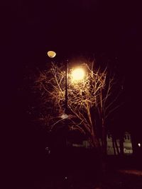 View of illuminated street lights at night